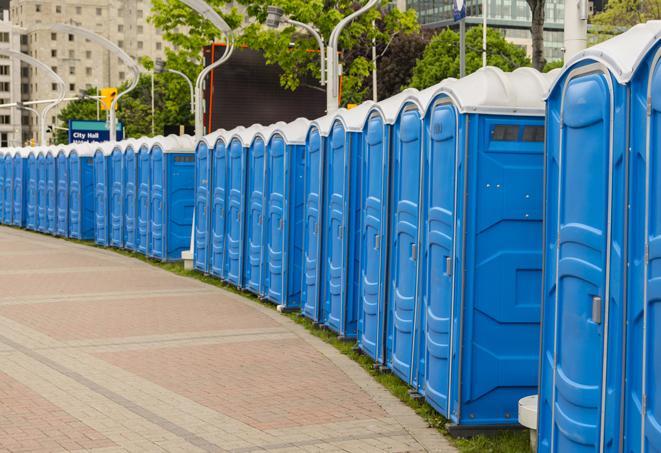 a line of portable restrooms at a sporting event, providing athletes and spectators with clean and accessible facilities in Middleborough, MA